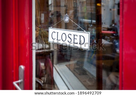 An image of an closed sign at the shop door