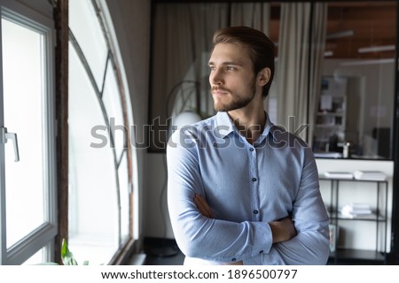 Close up confident businessman executive looking to aside out window, business vision concept, startup founder company owner boss visualizing future, new opportunities, thinking about future