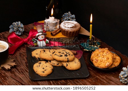 Festive table with cookies, candles and a snowman