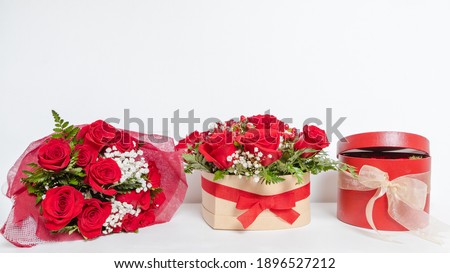 Various romantic gifts for Valentine's Day. Bouquet of red roses, floral box. Special gift for Valentine's Day, anniversary and birthday. Surprise for loved ones, proof of love