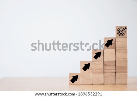 Virtual target board and increasing arrow which print screen on wooden cube. Business achievement goal and objective target concept. Royalty-Free Stock Photo #1896532291