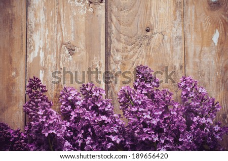 Bouquet of lilac flowers on a wooden board, floral background, rustic style decoration