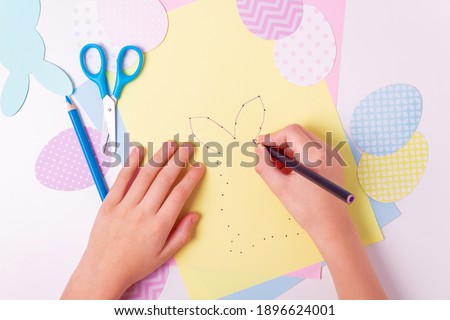 Easter activities. Dot to dot painting bunny game. Line art easter rabbit game for children. Dot to dot drawing activity page. Selective focus. Top view. Royalty-Free Stock Photo #1896624001