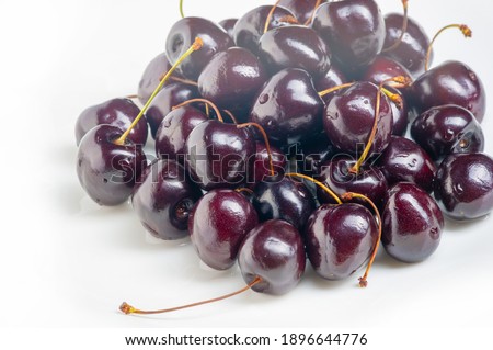 Photo of food. Red cherry with stem and leaves isolated on white background. Ripe red cherries. Sweet and juicy organic. Fresh fruits. Berry, nature.