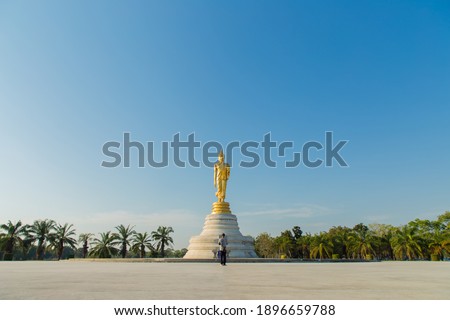 The standing buddha with blue sky,Copy space 
