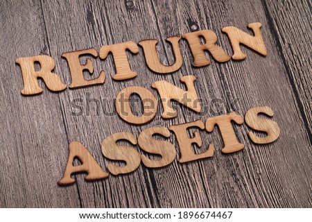 Return on Assets ROA, text words typography written on wooden background, life and business motivational inspirational concept