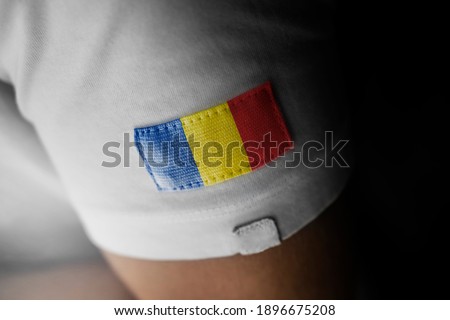 Patch of the national flag of the Romania on a white t-shirt