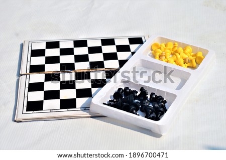 view of chess board with chess pieces on white background. Indoor game.