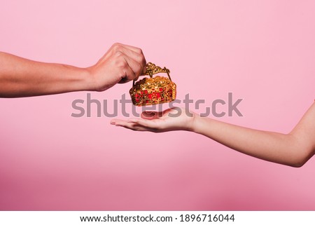 Close up hand sending and receiving red envelope Symbols of the Chinese New Year on golden bokeh background. gifts, festivals and celebration concept