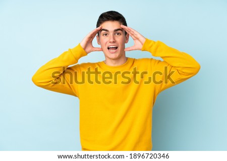Teenager caucasian handsome man isolated on purple background with surprise expression