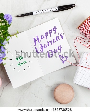 8'th March-Happy Women day postcard note on white marble table. Royalty-Free Stock Photo #1896730528