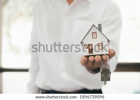 Real estate broker residential house rent listing contract. Offer of purchase house, rental of Real Estate. Giving, offering, demonstration, handing house keys. Royalty-Free Stock Photo #1896739096