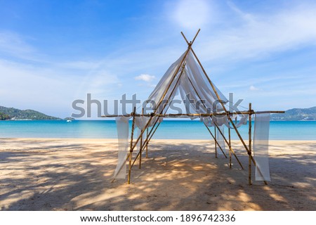 Beautiful tropical beach the calm sea with cloud and sky background. Sun over tropical beach. Nature summer  concept. Bamboo and white cloth theme for camera shot on beach