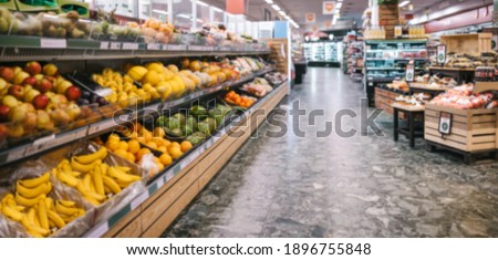 Fully stocked aisles in a grocery store. Assorted fruits and vegetables on racks in supermarket. Royalty-Free Stock Photo #1896755848