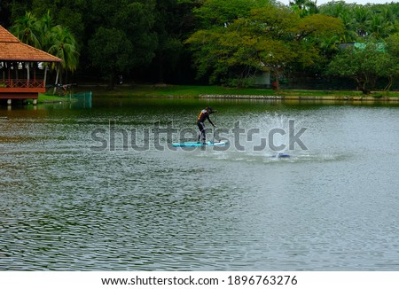 A picture of Shah Alam Lake with people playing paddleboard insight