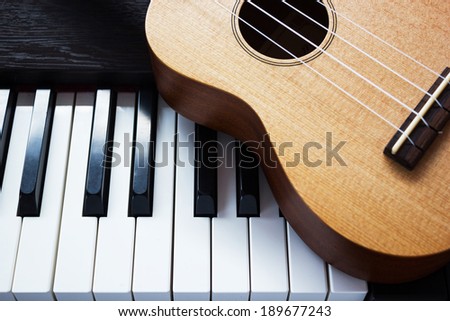 Piano key and ukulele. Art and music background. Top view. Classic and simple style.