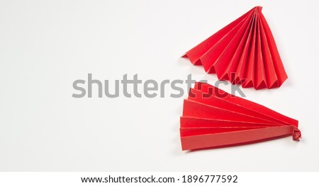 Banner with two red origami paper fans, copy space, space for text.