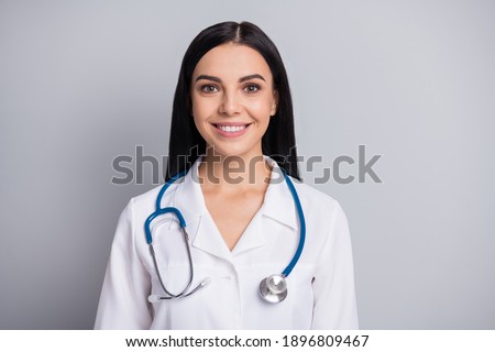 Photo of cheerful doctor woman look camera beaming smile wear stethoscope white uniform isolated grey color background