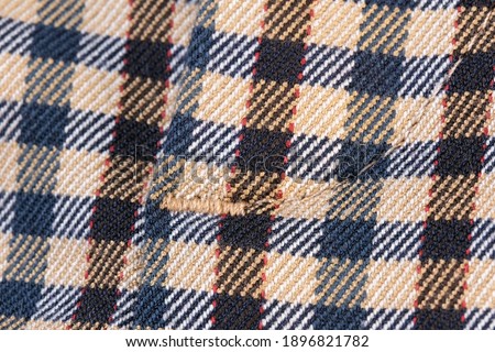 Textile textured background close-up macro photograph of a fragment of a female woolen dress machine knitted