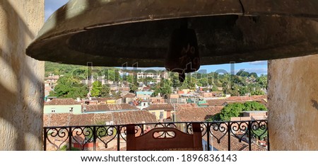 old historic bell in the foreground and view over trinidad on cuba