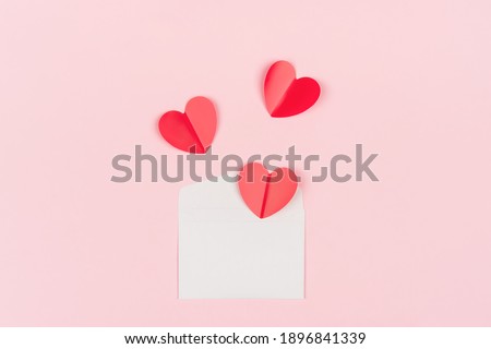 White envelope and red hearts on a pink background. Background for Valentine's Day, Wedding Day or Mother's Day. Place for text, mockup.