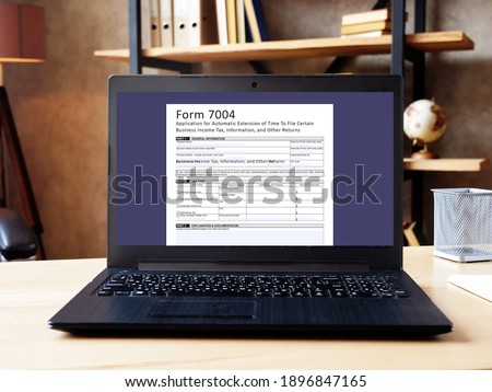 Business concept about  Form 7004 Application for Automatic Extension of Time To File Certain Business Income Tax, Information, and Other Returns  with phrase on the piece of paper. Royalty-Free Stock Photo #1896847165