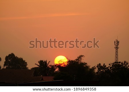 Big colorful sun during sunset  background.