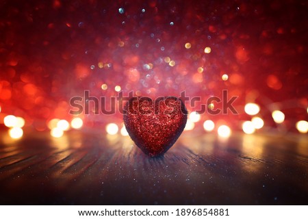 Valentine's day concept. Glitter red hearts over shiny background