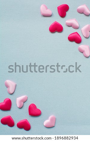 Pink hearts on blue paper background