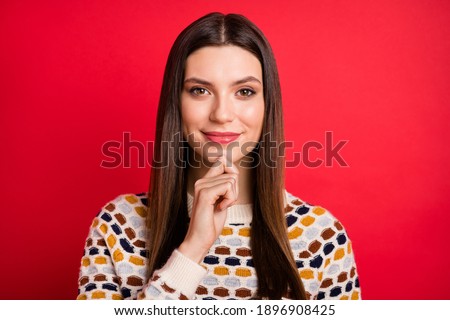 Portrait of optimistic girl finger chin wear colorful sweater isolated on red color background
