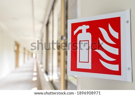 Close up fire extinguisher sign in the building corridor. Selective focus image. Emergency sign. Royalty-Free Stock Photo #1896908971