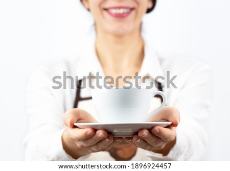 coffee time. A waiter holding and serving a glass of hot coffee, isolated in white background.
