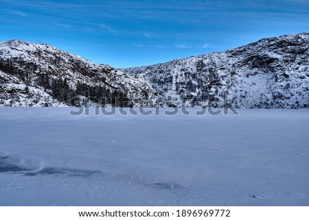 Snow on a frozen lake. Snow on the city mountains in Bergen, Norway in January