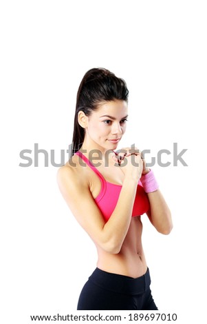 Young thoughtful sport woman standing over white background