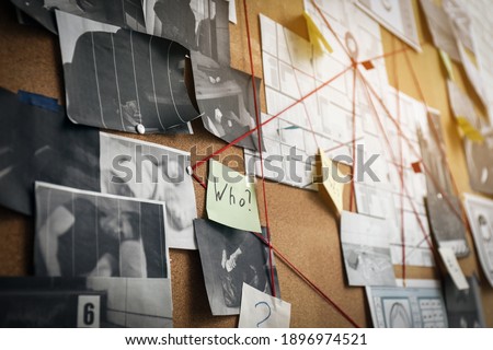 Detective board with sticker, crime scene photos and red threads, closeup