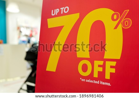 Large Sale 70% off letters on a paper board in a fashion store.