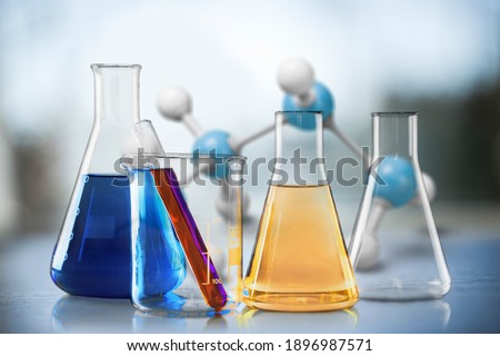 Glass test tubes with liquid stand on a table in a chemical laboratory. Checking the quality of petroleum products refining concept. Royalty-Free Stock Photo #1896987571