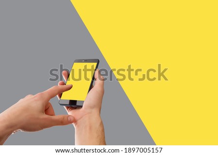 Designer top view with phone, Creative professional workspace. Colors of the year 2021 Ultimate Gray and Illuminating background. Trendy Illuminating Yellow.