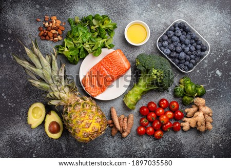 Anti inflammatory diet concept. Set of foods that help to reduce inflammation - plant based ingredients, fresh fruit, green vegetables. Healthy diet products, top view, stone background Royalty-Free Stock Photo #1897035580