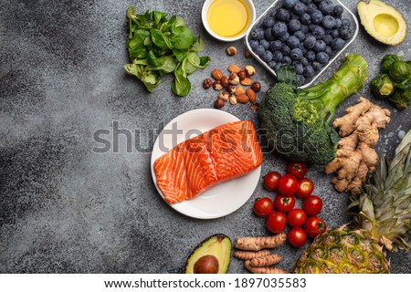 Anti inflammatory diet concept. Set of foods that help to reduce inflammation - plant based ingredients, fresh fruit, green vegetables. Healthy diet products, top view, stone background copy space Royalty-Free Stock Photo #1897035583