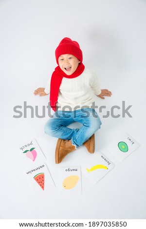 A boy with a white background learns English indoors on New Year's Day