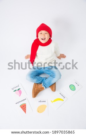 A boy with a white background learns English indoors on New Year's Day