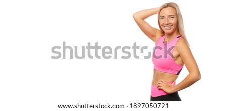 Close-up portrait of a joyful sporty girl with long hair on an isolated white background. Free space for text.