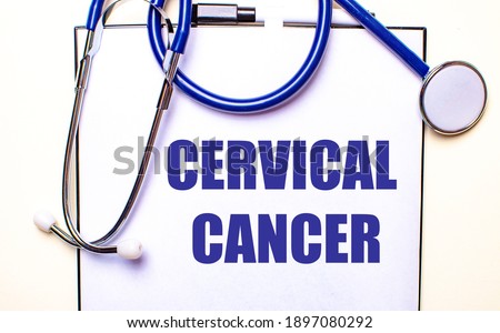 CERVICAL CANCER is written on a white sheet near the stethoscope. Medical concept