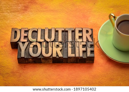 declutter your life - inspirational word abstract in vintage letterpress wood type with a cup of coffee, minimalism, business and lifestyle concept