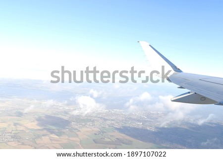 Beautiful white clouds floating high angle air with blue sky background, viewed from airplane window.