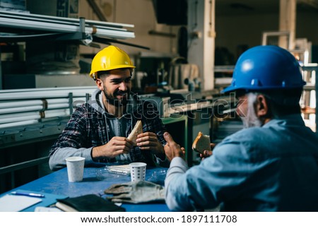 blue collar workers having lunch break Royalty-Free Stock Photo #1897111708