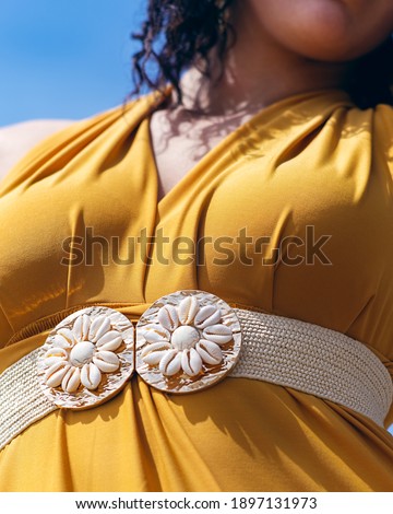 women's fashion accessories shot with a model posed casually outdoors during spring