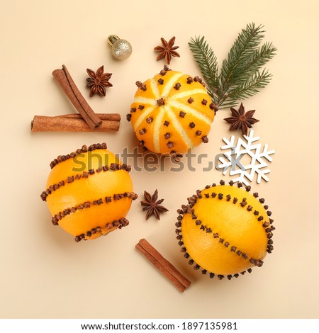 Flat lay composition with pomander balls made of fresh oranges on beige background