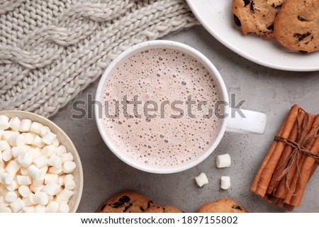 Flat lay composition with cup of delicious hot cocoa on grey table